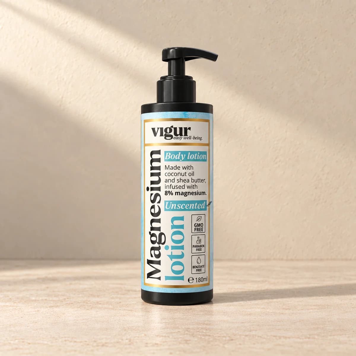 Høy hvit pumpeflaske med blå etikett merket Vigur og «Magnesium lotion» på beige bakgrunn